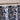 Blue floral patterned shower curtain on a rod against a beige wall