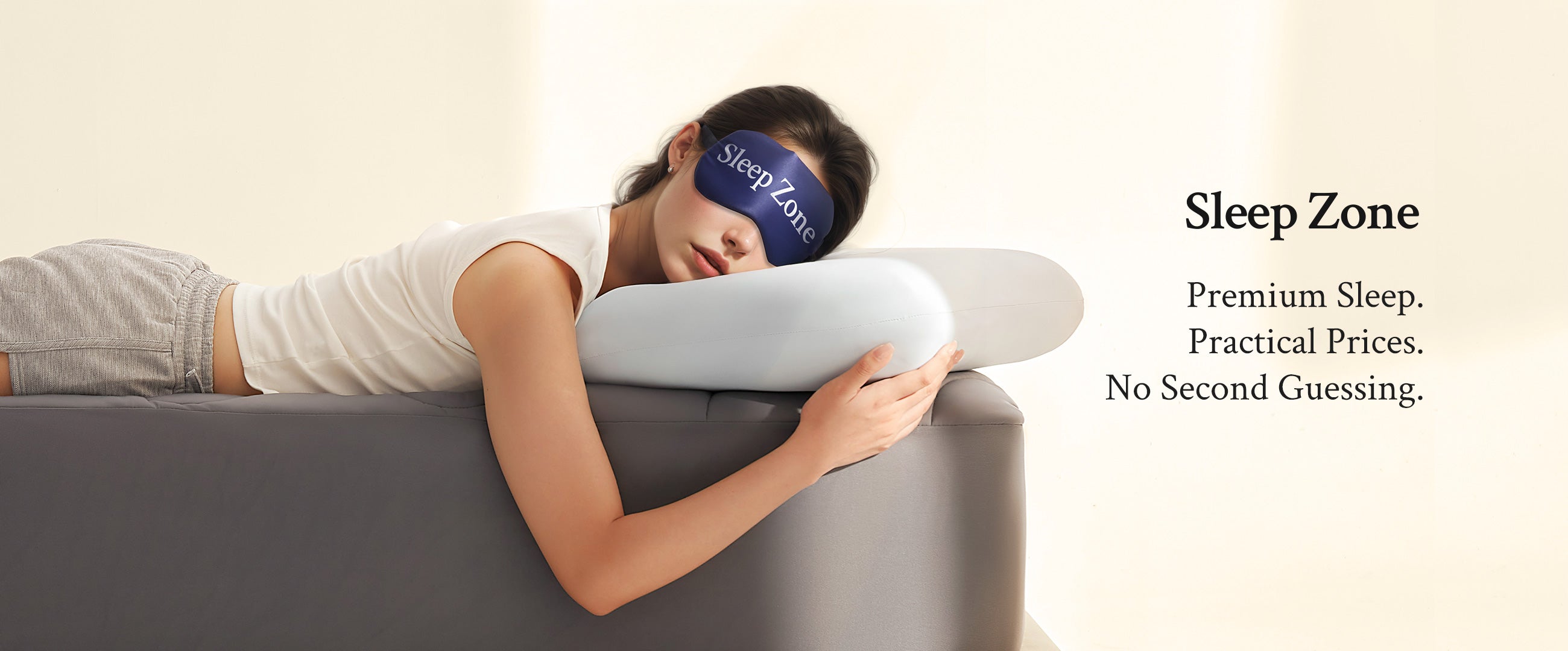 Person using a sleep zone product with a pillow and eye mask on a couch.
