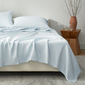 Blue European linen sheet set styled on a modern bed