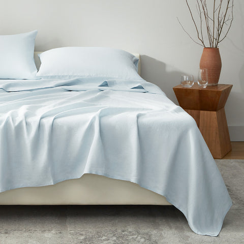 Blue European linen sheet set styled on a modern bed
