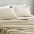 Beige European linen bedding set with pillows on a neutral background