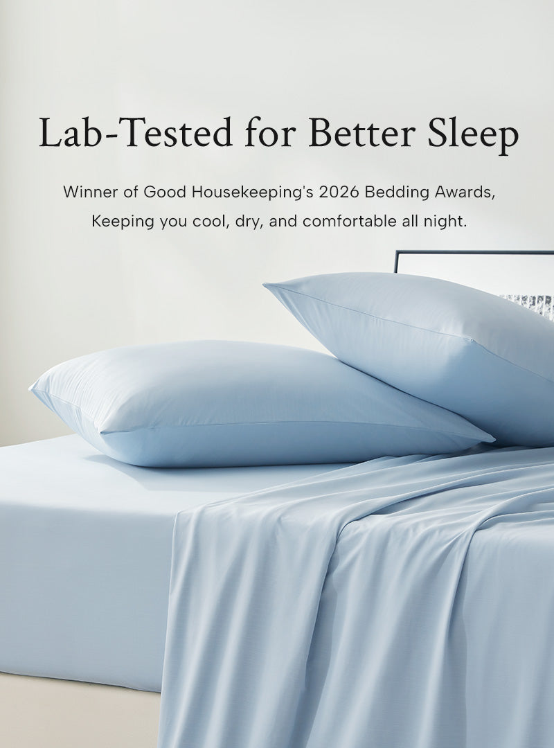 Light blue cooling sheet bedding set with pillows on a bed, featuring text about lab-tested sleep comfort.