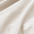 Close-up of textured beige fabric with folds
