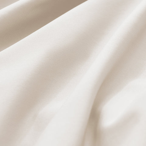 Close-up of textured beige fabric with folds
