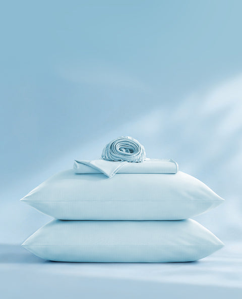 stack of cooling sheet set on a lightblue background