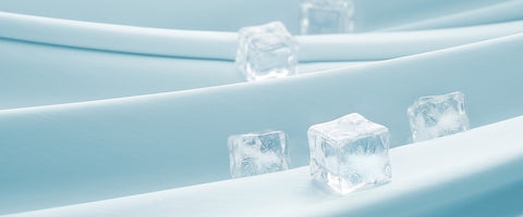 Ice cubes on a light blue cooling tech fabrics