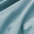 Close-up of textured blue fabric with folds