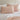 blush pillows on a bed with blush cotton duvet cover set against a neutral wall
