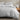 dove cotton duvet cover set on a bed with a wooden nightstand and decorative items.
