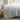long side view of dove cotton duvet cover set on a bed in a room with a window showing a garden view
