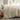 long side view of oyster cotton duvet cover set on a bed in a room with a window showing a garden view
