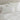White pillows on a bed with white cotton duvet cover set against a neutral wall