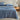 trailing-leaf cotton jersey sheet set on a bed with a wooden nightstand and decorative items.
