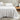 white cotton jersey sheet set on a bed with a wooden nightstand and decorative items.

