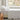 long side view of white cotton jersey sheet set on a bed in a room with a window showing a garden view
