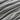 Close-up of dark gray fabric with wavy pattern
