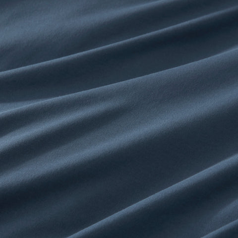 Close-up of a midnight cotton jersey pillowcase, emphasizing smooth, breathable texture for comfortable sleep
