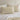 a close-up view of oyster cotton jersey pillowcase set on a white bed against a neutral wall.
