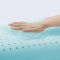 Hand on a blue gel pillow with a light gray background